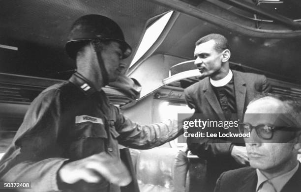 Traveling with Freedom Riders on historic ride from Montgomery to Jackson, MS, Rev. C.T. Vivian pleading with officer to make rest stop.