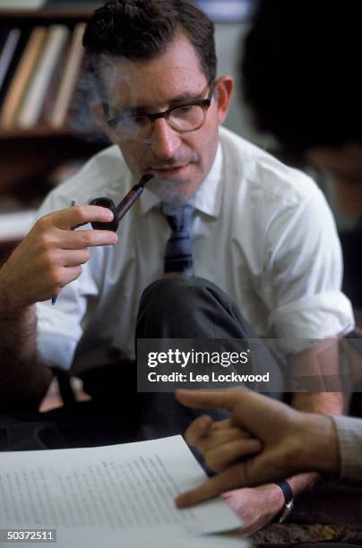 Linguistic expert and political activist Noam Chomsky, smoking pipe, in his office.