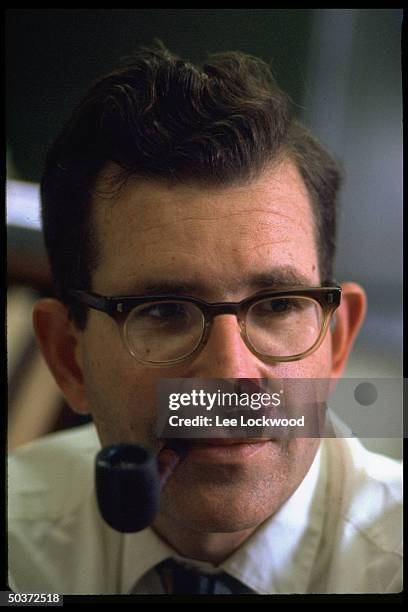 Linguistic expert and political activist Noam Chomsky, smoking pipe, in his office.