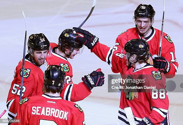 Brent Seabrook, Erik Gustafsson, Artemi Panarin, Artem Anisimov and Patrick Kane congratulate Panarin after his second goal of the game against the...