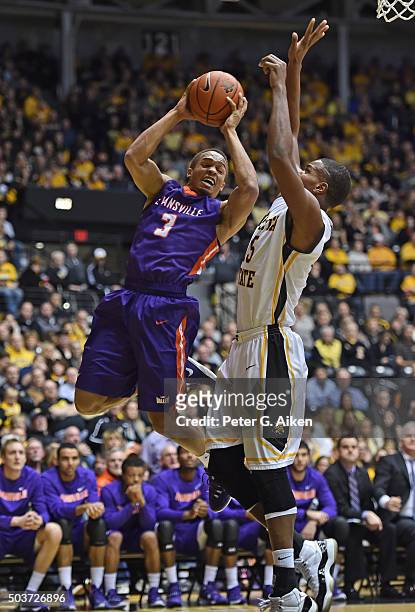 Guard Jaylon Brown of the Evansville Aces drives to the basket against forward Anton Grady of the Wichita State Shockers during the second half on...