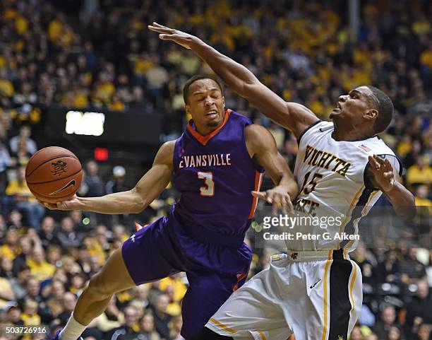 Guard Jaylon Brown of the Evansville Aces drives to the basket against forward Anton Grady of the Wichita State Shockers during the second half on...