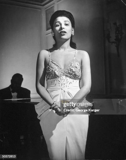 Singer Lena Horne singing Cole Porter's Let's Do It w/o a microphone in front of rapt guests in Savoy-Plaza Hotel's Cafe Lounge.