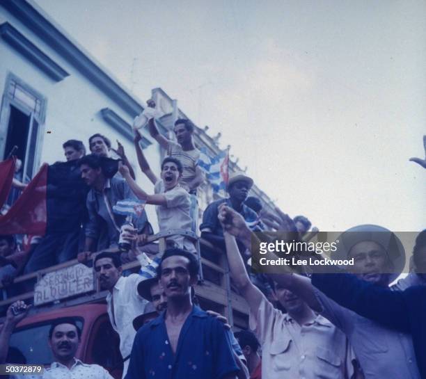 Jubilant population gathering on Havana streets as victorious Castro and rebel army head toward city.