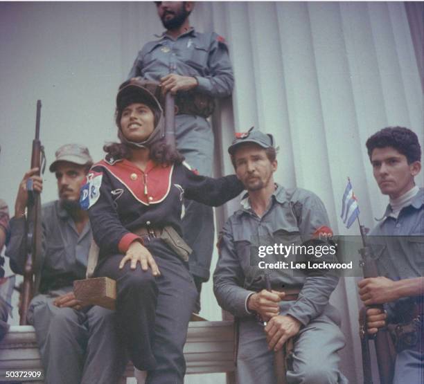 Woman of the 26th of July militia standing guard w. Fellow rebels during one of Castro's lengthy victory speeches en route to Havana