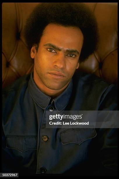 Activist Huey P. Newton, with Afro haircut, in his penthouse living room.