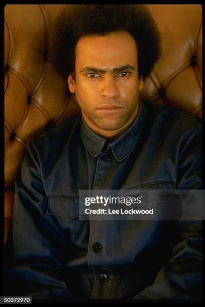 Activist Huey P. Newton, with Afro haircut, in his penthouse living room.