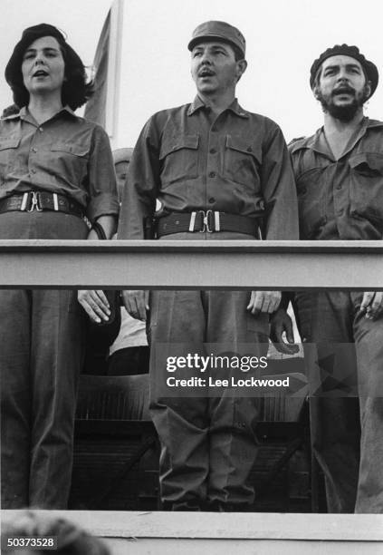 Celia Sanchez, confidante of Fidel Castro, Raul Castro, brother of Fidel, and Che Guevara, hero of the revolution, appearing on viewing stand during...