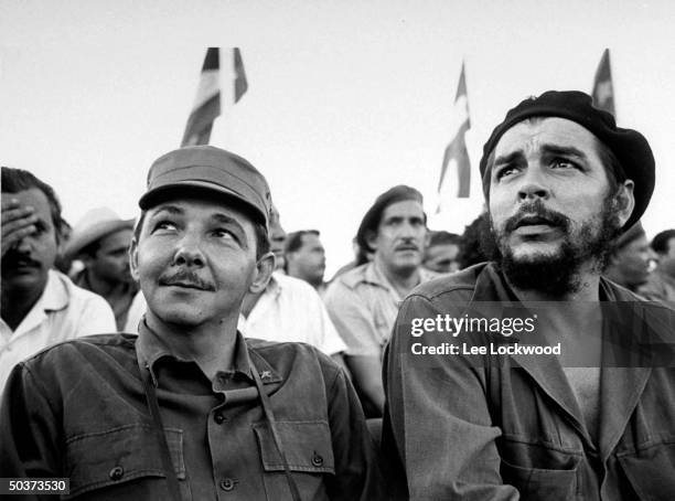 Che Guevara, Cuban hero, and Raul Castro, brother of Fidel, sitting on viewing platform during July 26th celebration of the revolution.