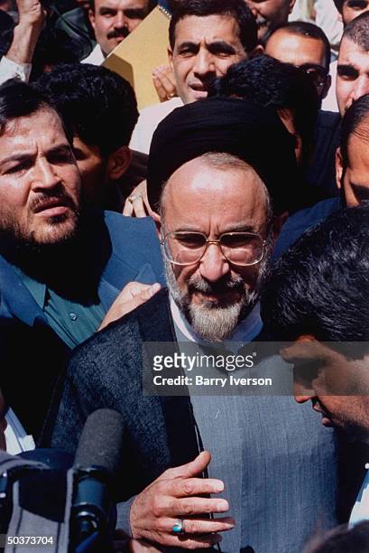Moderate cleric presidential candidate Mohammed Khatami , surprise front-runner, greeting supporters outside polling station on election day.