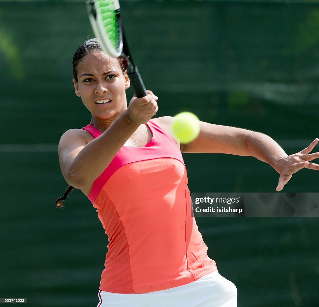 Mixed race Woman Playing Tennis
