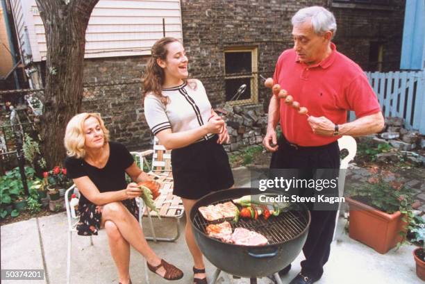 Actress Hillary Wolf, who is a member of the 1996 US Olympic women's judo team, barbecuing w. Divorced parents Malcolm & Marilyn in backyard of...
