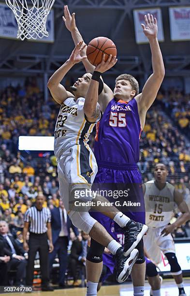 Guard Fred VanVleet of the Wichita State Shockers drives in for a basket against center Egidijus Mockevicius of the Evansville Aces during the first...