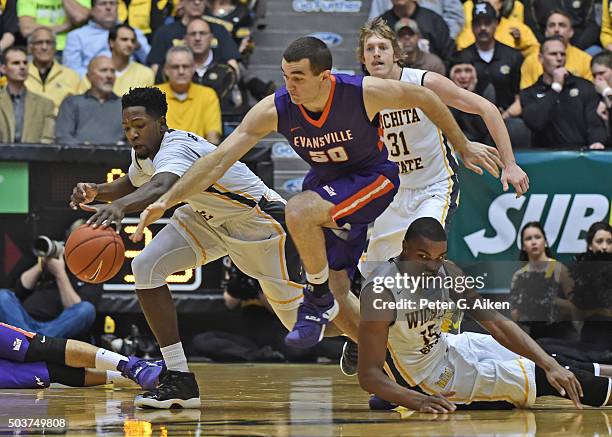 Forward Blake Simmons of the Evansville Aces reaches for a loose ball against forward Zach Brown of the Wichita State Shockers during the first half...