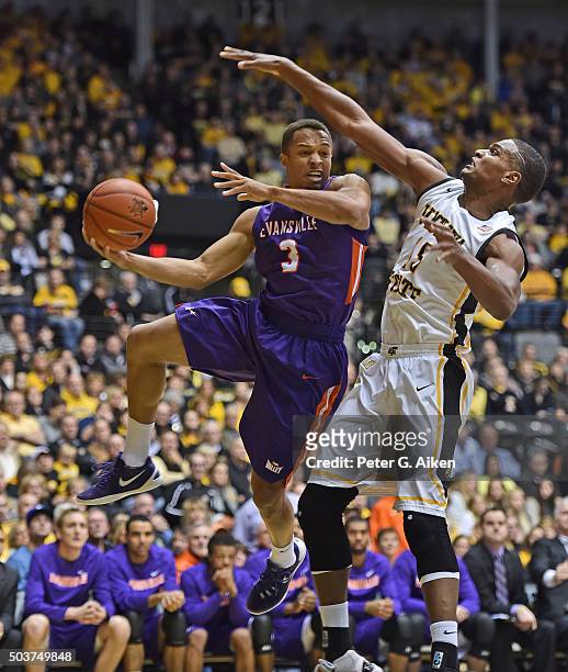 Guard Jaylon Brown of the Evansville Aces drives with the ball against forward Anton Grady of the Wichita State Shockers during the second half on...