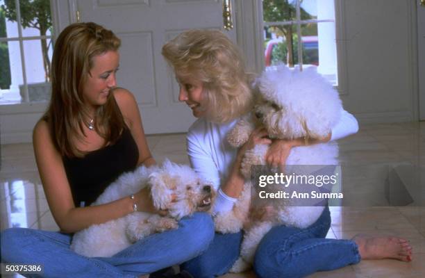Political Commentator & activist Susan Carpenter McMillan with daughter Cameo cuddling their two pet bichon dogs in their San Marino home....