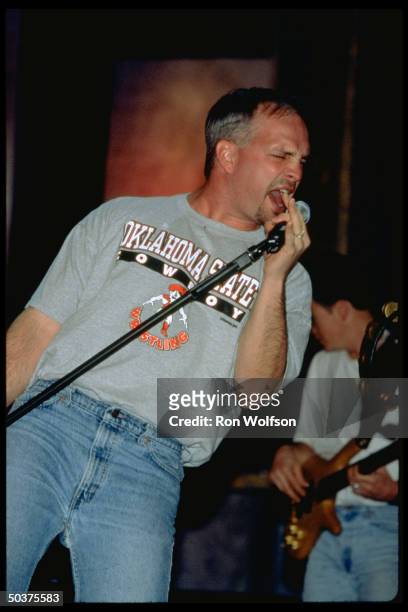 Singer Garth Brooks, wearing Oklahoma State Cowboy t-shirt, performing.