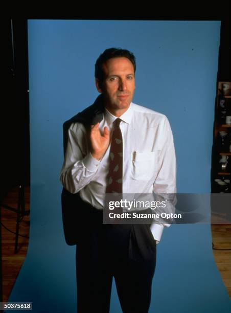 Starbucks CEO Howard Schultz w. Suit jacket draped over shoulder.