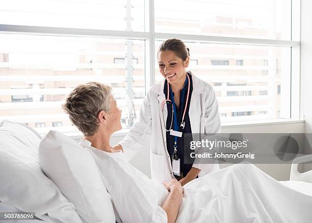 ethnic female consultant smiling and talking with patient - patientkontakt bildbanksfoton och bilder