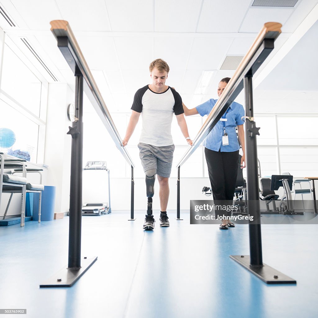 Young disabled man using orthopedic equipment to walk