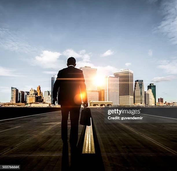 businessman walking towards futuristic city - seize opportunity stock pictures, royalty-free photos & images