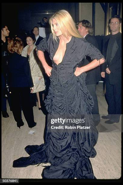 Actress Peta Wilson wearing full length Norma Kamali evening gown to New York City costume retrospective.