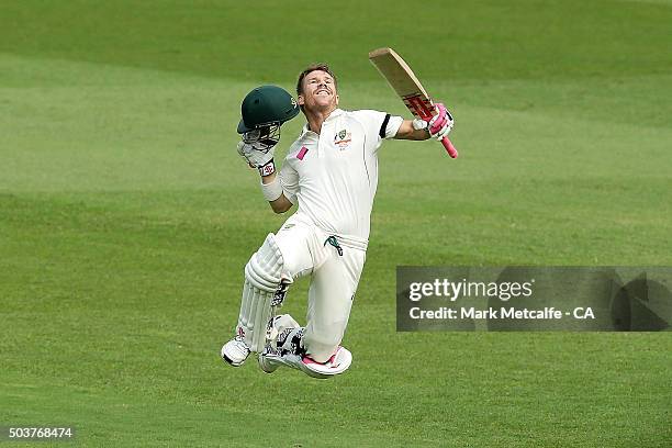 David Warner of Australia celebrates and acknowledges the crowd after scoring a century during day five of the third Test match between Australia and...