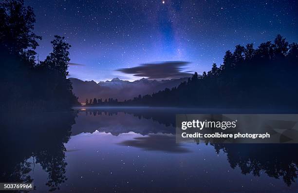 night shot at lake matheson with stars - lake matheson new zealand stock pictures, royalty-free photos & images