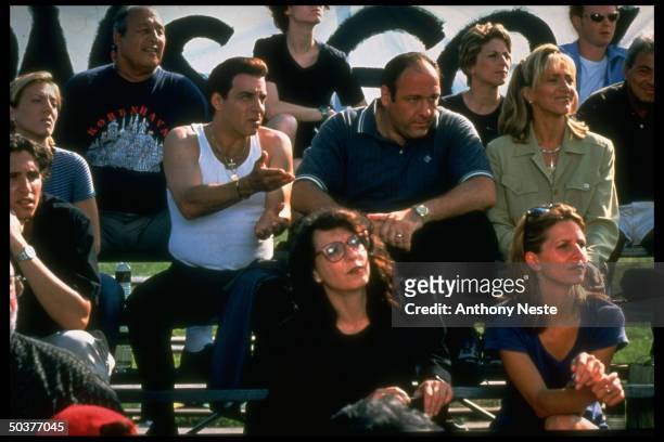 Former E Street Band guitarist & actor Stevie Van Zandt & actor James Gandolfini, chatting at a sporting event in a scene from the HBO crime series...
