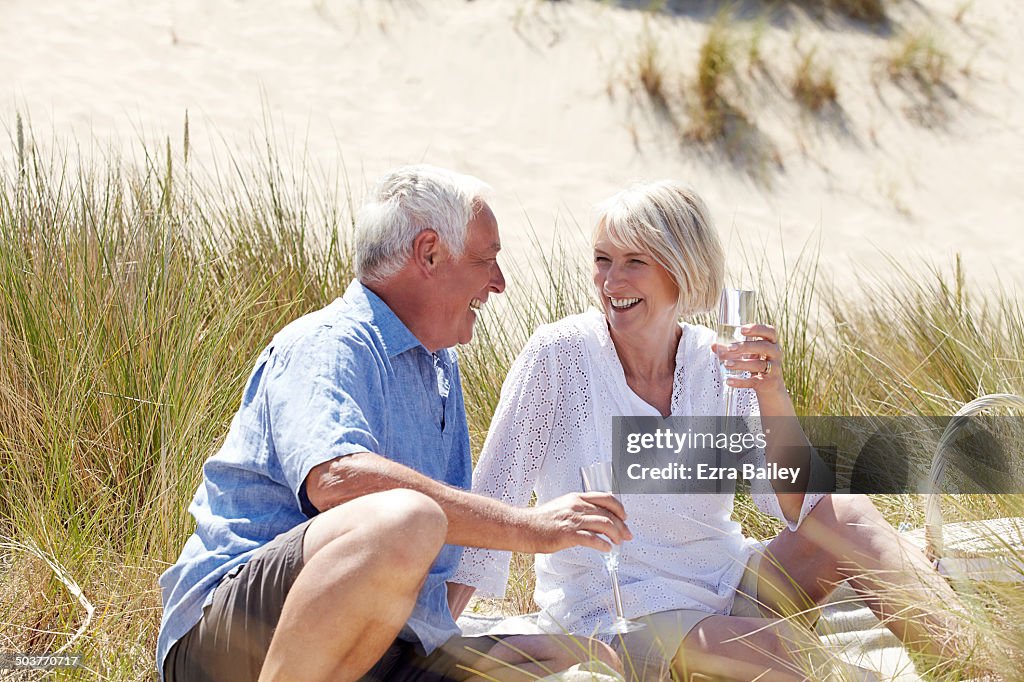 Mature couple celebrating on the beach.