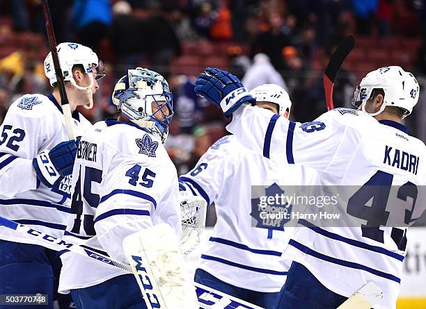 Jonathan Bernier of the Toronto Maple Leafs celebrates a 4-0 win over the Anaheim Ducks with Martin Marincin, Roman Polak and Nazem Kadri at Honda...