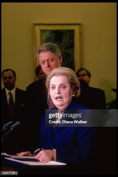 State Secy. Madeleine Albright speaking, Pres. Bill Clinton poised behind her, during her swear-in ceremony in White House Oval Office.