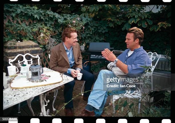James Hewitt , ex-cavalry officer & former lover of England's Princess Diana, chatting w. Cavalry pal Rupert MacKenzie-Hill on his patio