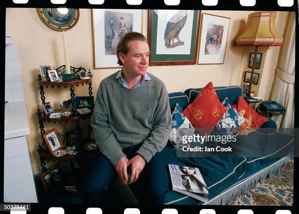 Portrait of James Hewitt, ex-cavalry officer & former lover of England's Princess Diana, posing in his apt.