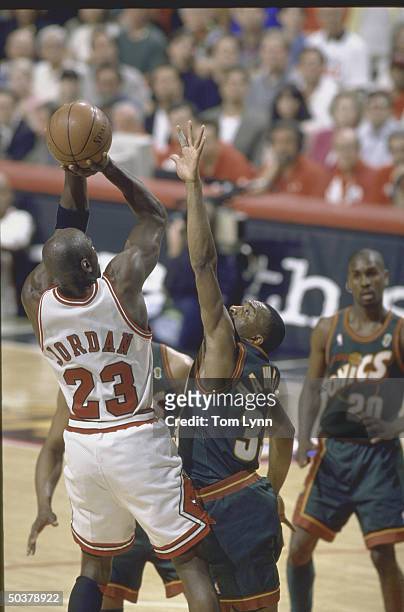 Finals Game 6. Rear view of Chicago Bulls Michael Jordan in action, shooting vs Seattle SuperSonics Hersey Hawkins.