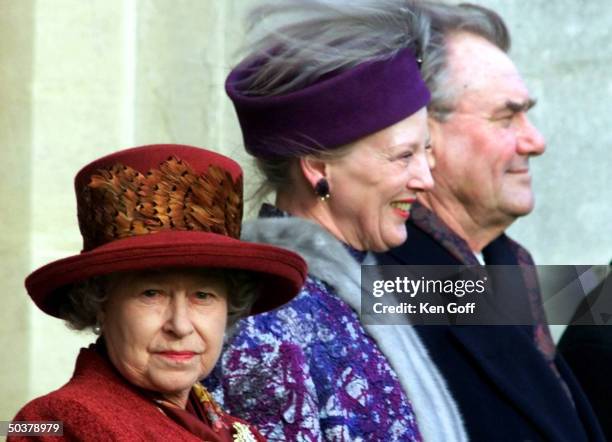 England's Queen Elizabeth II with Denmark's Queen Margrethe & Prince Henrik listening to playing of Danish national anthem during three-day state...