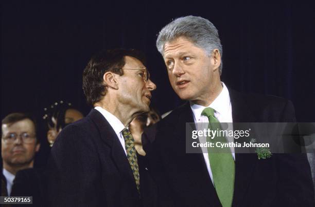 Senate Minority Leader Tom Daschle w. Saint Patrick's Day green tie & lapel shamrocks-sporting Pres. Bill Clinton during Capitol Hill health care...