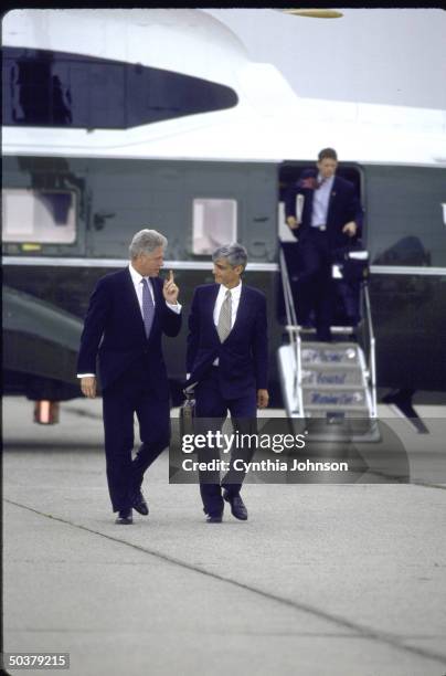 Pres. Bill Clinton chatting w. Treasury Secy. Robert Rubin while walking from Marine One copter to Air Force One, departing JFK Airport.