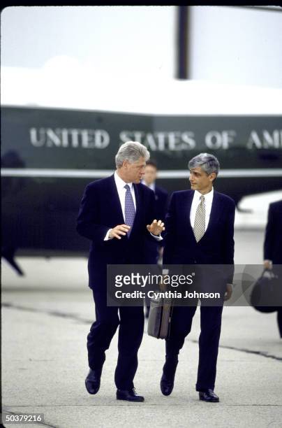 Pres. Bill Clinton chatting w. Treasury Secy. Robert Rubin while walking from Marine One copter to Air Force One, departing JFK Airport.