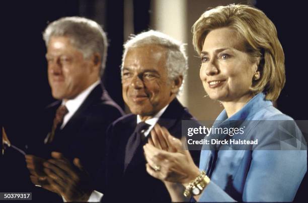 Pres. Bill & Hillary Rodham Clinton flanking Ralph Lauren during ceremony at Smithsonian announcign fashion designer's gift funding restoration of...