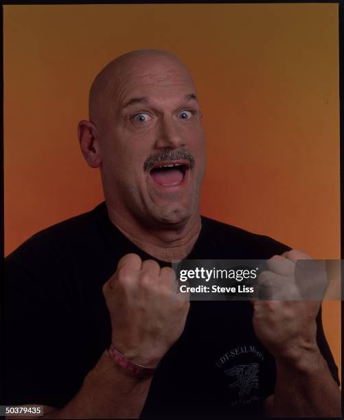 Minnesota Gov-elect Jesse Ventura, former pro wrestler, putting up his dukes in smiling portrait.