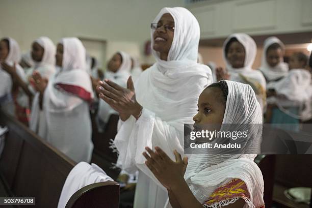 Ethiopian Orthodox Christians living in South Africa attend the Orthodox Christmas mass at the Tewahedo Holy Trinity church in Johannesburg, South...