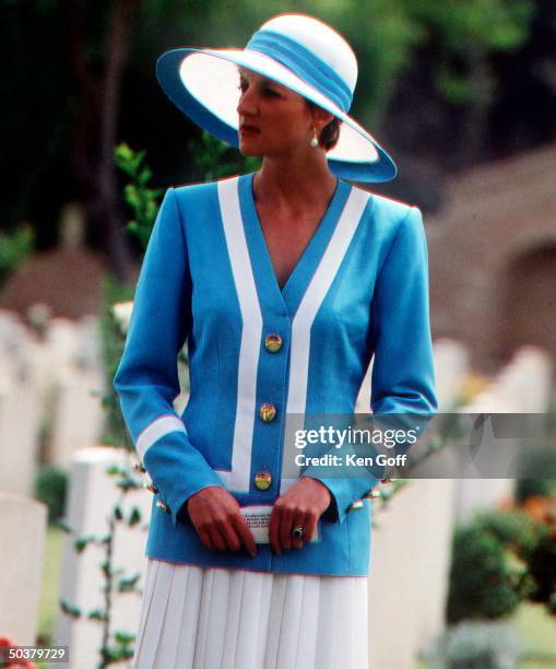 Princess Diana wearing blue & white top, white pleated skirt & white wide-brimmed hat w. Blue band during a tour of India.