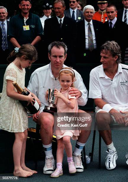 Tennis player John McEnroe w. Two of his daughters & opponent Bjorn Borg at charity tennis event at Buckingham Palace for the National Society for...