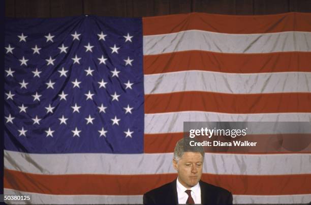 Pres. Bill Clinton speaking at John F. Kennedy Space Center against US flag backdrop.