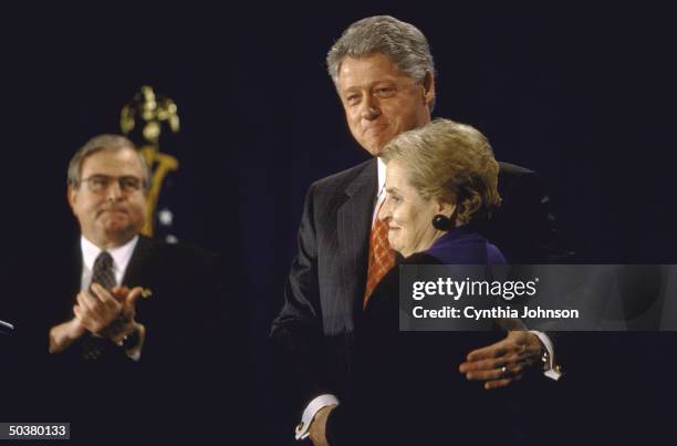 Pres. Bill Clinton w. Fond arm around Secy. Of State Madeleine Albright during foreign policy event .