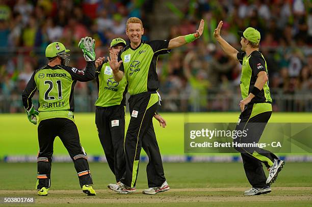 Andrew McDonald of the Thunder celebrates after taking the wicket of Shaun Marsh of the Scorchers during the Big Bash League match between the Sydney...