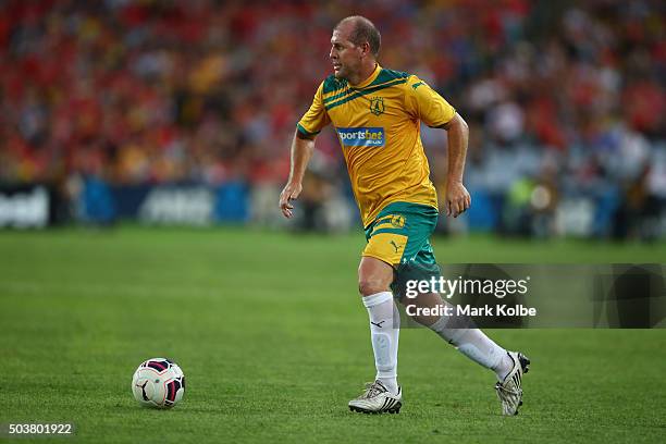 Scott Chipperfield of the Australian Legends runs the ball forward during the match between Liverpool FC Legends and the Australian Legends at ANZ...