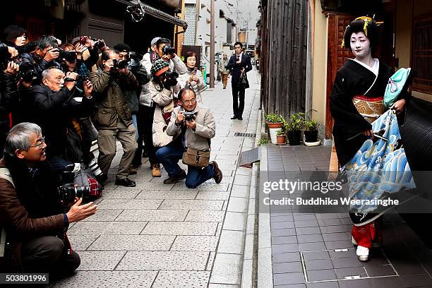 Japanese traditional female dancer, maiko poses for pictures during the new year's ceremony at the Gion Kobu Kaburenjo Theater on January 7, 2016 in...