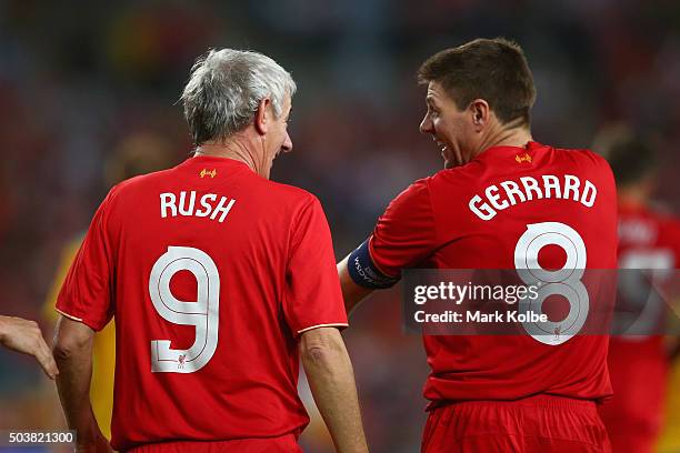 Ian Rush of the Liverpool FC Legends shares a laugh with Steven Gerrard of the Liverpool FC Legends as he celebrates scoring a goal during the match...